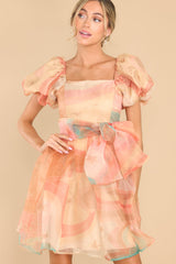 Front view of this dress that showcases a subtle pattern in shades of orange and blue.