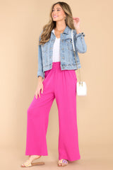 Full body view of these pants that feature a high rise elastic waist, pockets at the hip, and a wide leg.