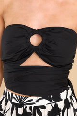 Close up view of this set that features a bandeau-style top with a sweetheart neckline, a ring detail at the center of the bust with a small cutout below, and an adjustable self-tie in the back.