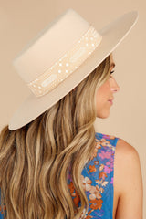 Side view of this hat that features a wide brimmed boater style shape, pink patterned ribbon, custom lining, and an UPF rating of 50+.