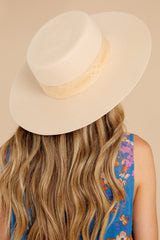 This gold and beige hat features a wide brimmed boater style shape, pink patterned ribbon, custom lining, and an UPF rating of 50+.