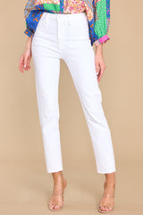 These white jeans feature a high rise design, a traditional zipper and button closure, functional front and back pockets, and a straight leg style.