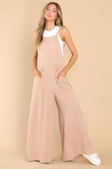 Full body view of this jumpsuit that feature functional front pockets and a flowy wide leg design.