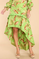 Front view of this skirt that features a high waist, zipper down the side, and a tiered flowy high low silhouette. 