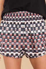 These black and pink shorts feature a high elastic waistband, a stretchy, fitted lining, and a fun pattern throughout.