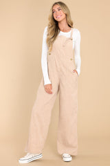 Full body view of these overalls that feature adjustable self-tie straps and four functional side pockets and two back pockets.
