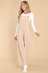 Front view of these overalls that feature adjustable self-tie straps, four functional side pockets and two back pockets, buttons below the bust to allow for a folded look, and a corduroy texture throughout.