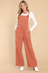 Full body view of these overalls that feature adjustable self-tie straps, four functional side pockets and two back pockets, buttons below the bust to allow for a folded look, and a corduroy texture throughout.