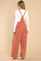 Back view of these overalls that feature adjustable self-tie straps, four functional side pockets and two back pockets, buttons below the bust to allow for a folded look, and a corduroy texture throughout.