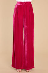 Front view of these pants that feature a high waist velvet-like material, two functional waist pockets, and a back zipper hook and eye closure.