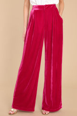 These hot pink pants feature a high waist velvet-like material, two functional waist pockets, and a back zipper hook and eye closure.