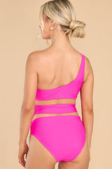 Back view of this one-piece that features a one shoulder neckline, mesh cutouts around the waist, and removeable padding.