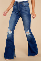 Front view of these jeans that feature light distressing throughout, wide legs, functional pockets, and a standard zipper and button closure.