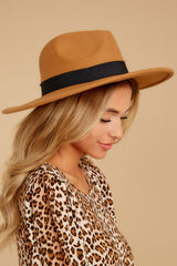 Side view of this wide brimmed hat that features a black ribbon band.