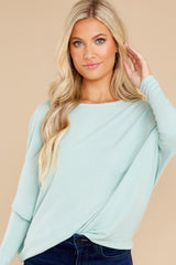 Front view of this pull over top that features a round neckline and long dolman sleeves.