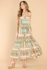 Full body view of this dress that features a v-neckline, pleated detailing at the waist, and a wide, flowy skirt.