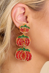 These orange statement earrings feature a beaded pumpkin design, sewn details, felt back, and a secure lock back fastening. 