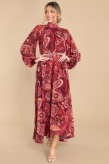Full body view of this dress that showcases a bohemian pattern in shades of red.