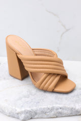 Outer-side view of these heels that feature a square heel, two crossed straps across the top of the foot, and a chunky block heel.