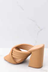 Inner-side view of these heels that feature a square heel, two crossed straps across the top of the foot, and a chunky block heel.