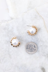 Pearl gold earrings compared to quarter for actual size. Earrings measure 1