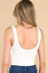Back view of this bodysuit that features thick straps, a double scoop neckline, and a thonged bottom. 