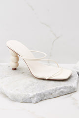 Close up view of these heels that feature a square toe and straps across the top of the foot.