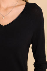 Close up view of this top that features a slight v-neckline with a raw hemline, 3.5