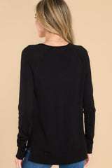 Back view of this top that features a slight v-neckline with a raw hemline, 3.5
