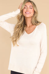 This oatmeal colored top features a slight v-neckline with a raw hemline, 3.5