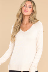 Front view of this top that features a slight v-neckline with a raw hemline, 3.5