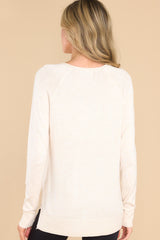 Back view of this top that features a slight v-neckline with a raw hemline, 3.5