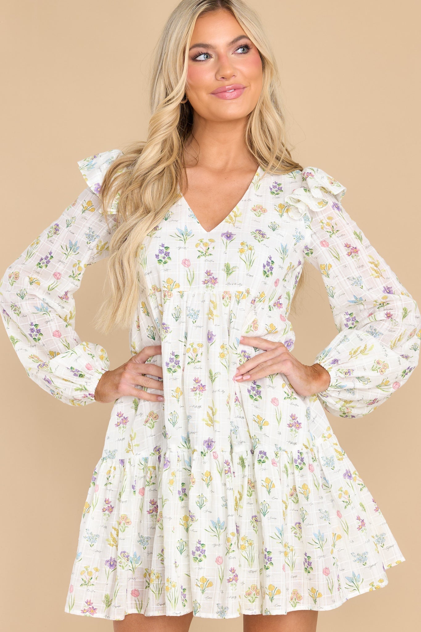 Front view of this dress that showcases the floral pattern of the ivory fabric.
