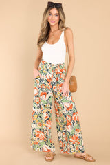 Full body view of these pants that feature an elastic waistband with an adjustable self-tie and a wide-leg.