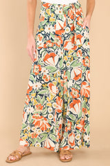 Front view of these pants that showcase the green and orange floral pattern.